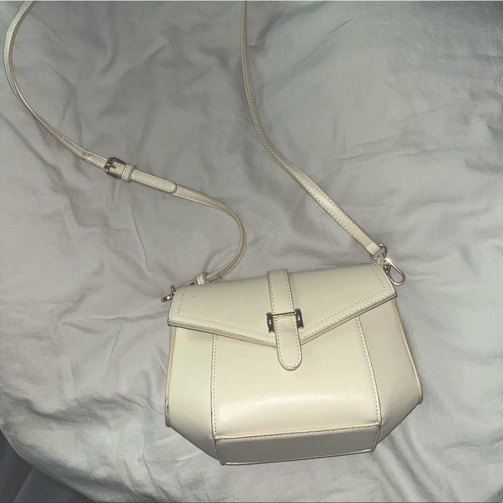Madison West cream colored crossbody bag.